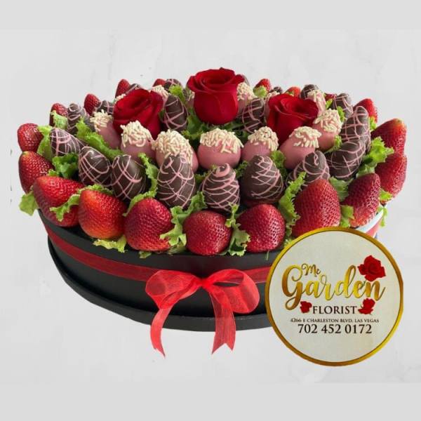Chocolate-covered strawberries and red roses in a round gift box