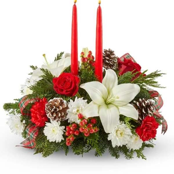 Holiday centerpiece with red candles, white lilies, and pinecones