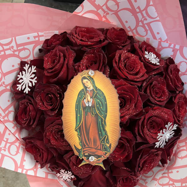 Heart-shaped bouquet of red roses with a religious centerpiece