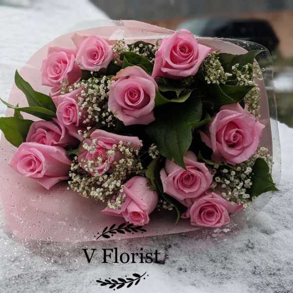 Pink rose bouquet wrapped in pale pink paper