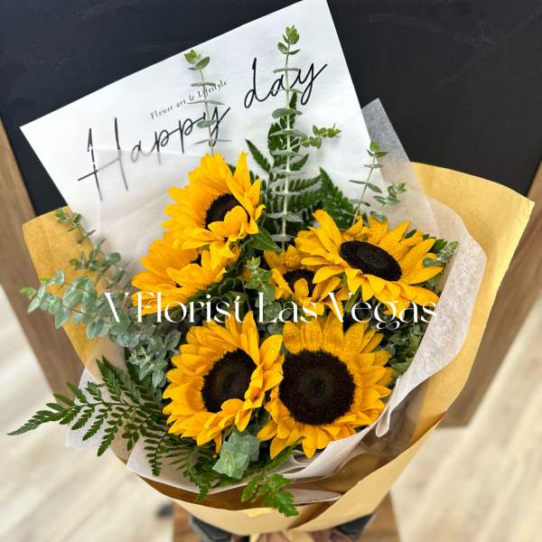 Bouquet of yellow sunflowers wrapped in paper