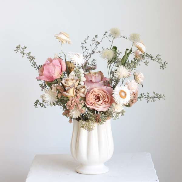 Pink and white bouquet in a white vase