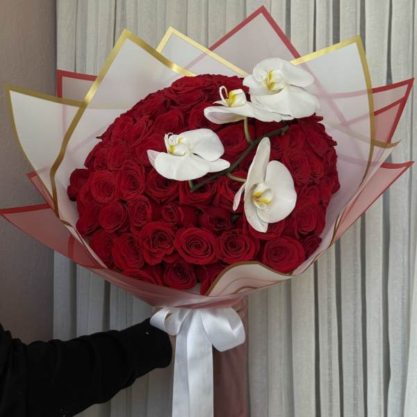 Large bouquet of red roses with white orchids and a white ribbon