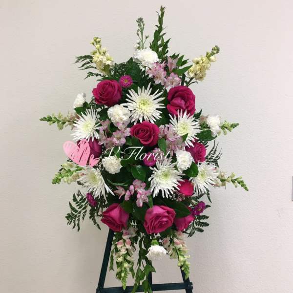 Standing floral spray with pink roses and white daisy-like blooms