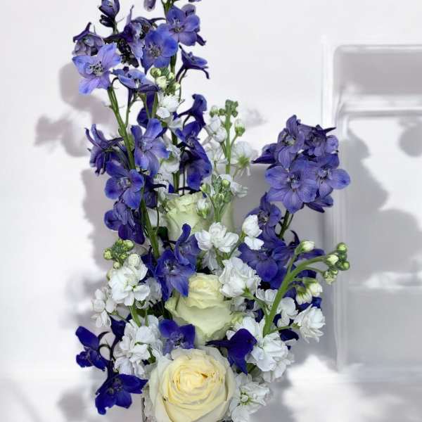 Blue and white floral arrangement in a patterned vase
