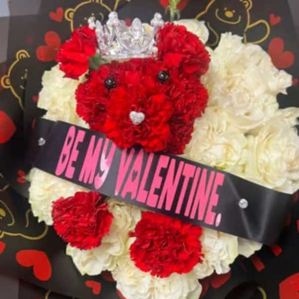 Red and white carnation bouquet with a crown and "Be My Valentine" ribbon