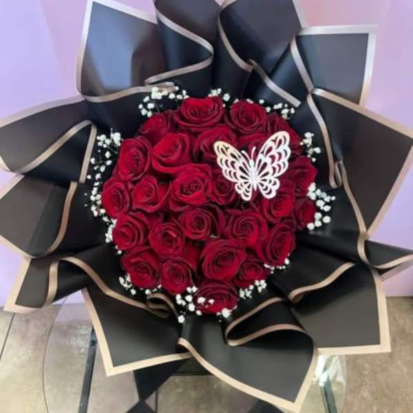 Red rose bouquet with black wrapping and a white butterfly accent