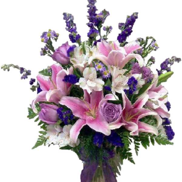 Bouquet of pink lilies, purple roses, and white flowers in a vase