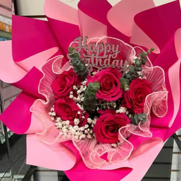 Bouquet of pink roses with a Happy Birthday topper