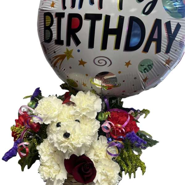 Birthday balloon above a basket of white and red carnations