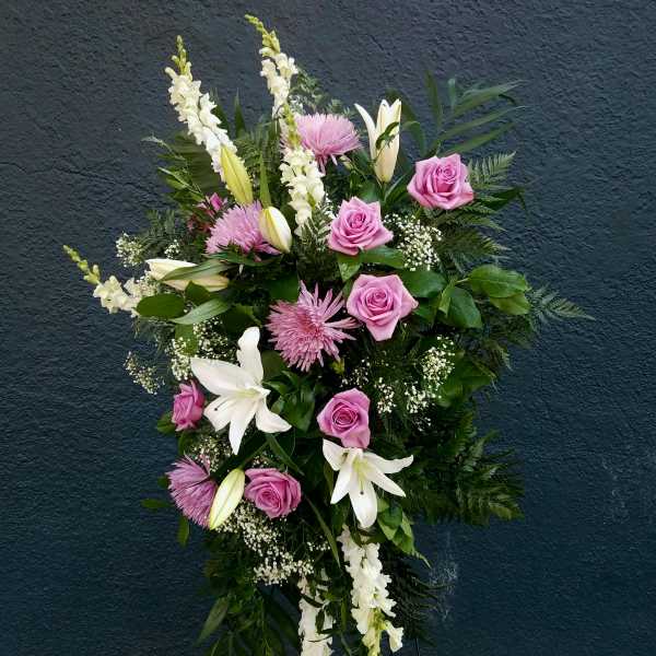 Standing floral spray with pink roses, white lilies, and white snapdragons