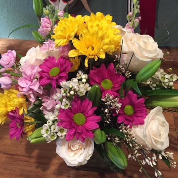 Mixed bouquet of yellow, pink, and white flowers