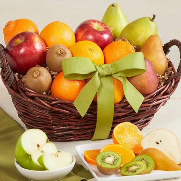Fruit basket with apples, pears, oranges, and kiwi slices tied with a green ribbon