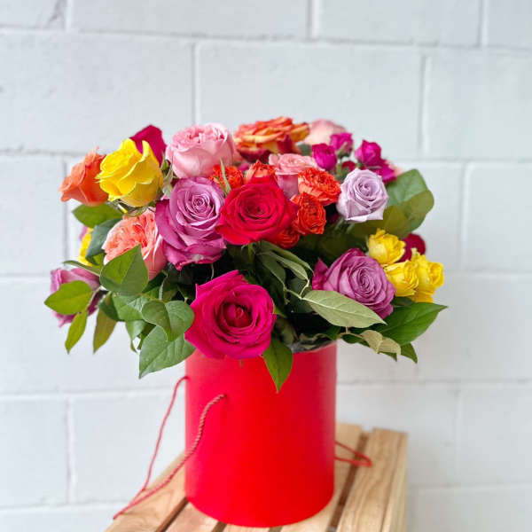Mixed roses in a red cylindrical box