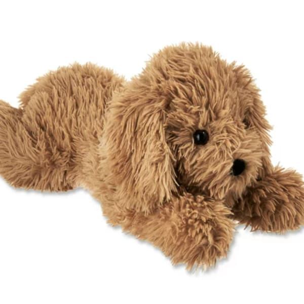 Brown plush dog toy lying down on a white background