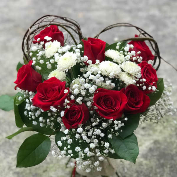 Bouquet of red roses and white baby's breath with greenery