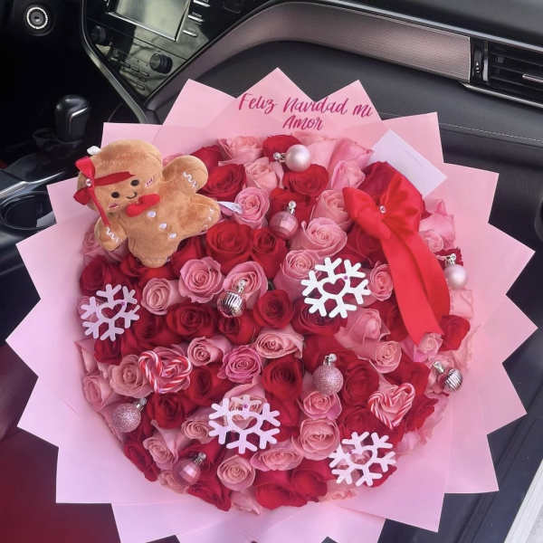 Pink and red rose bouquet with a teddy bear and holiday ornaments