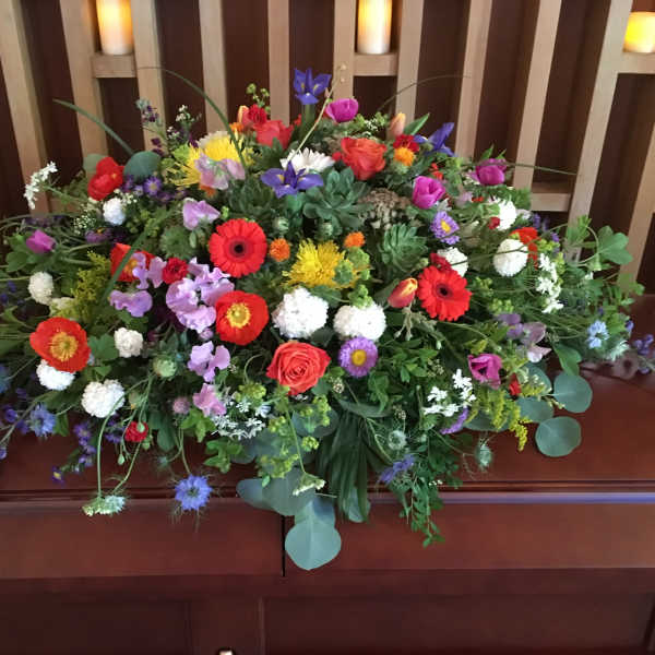Large colorful floral casket spray with mixed blooms