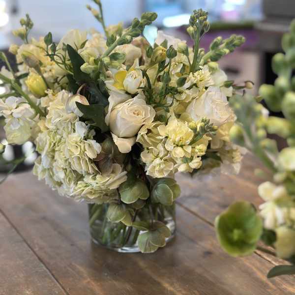 Cream and pale yellow bouquet in a clear glass vase