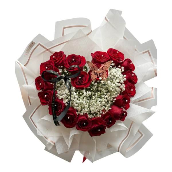 Heart-shaped bouquet of red roses with baby's breath and a butterfly accent