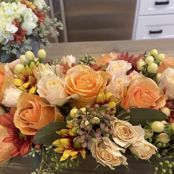 Peach and cream rose bouquet with yellow-red daisies and berry accents