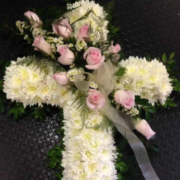 White floral cross with pink roses and ribbon
