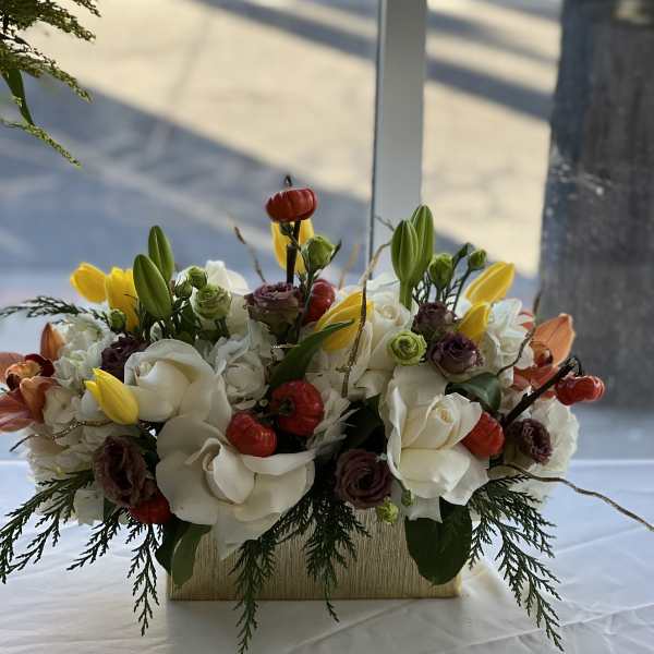 White and yellow floral arrangement in a rectangular vase