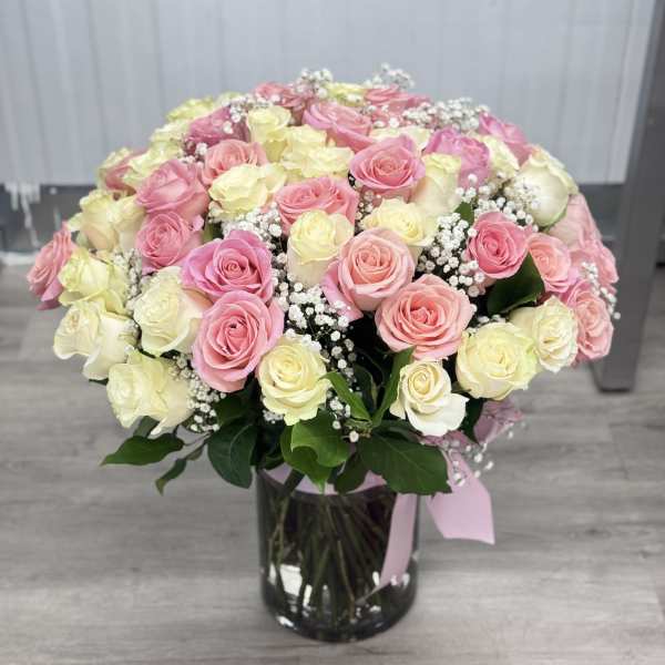 Bouquet of pink and cream roses in a glass vase
