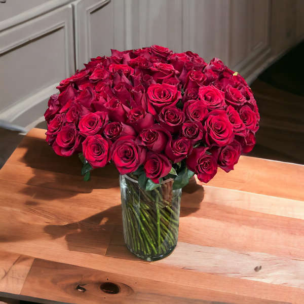 Large bouquet of red roses in a clear glass vase