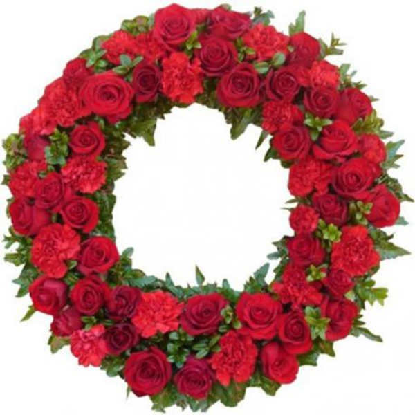 Circular wreath of red roses and carnations