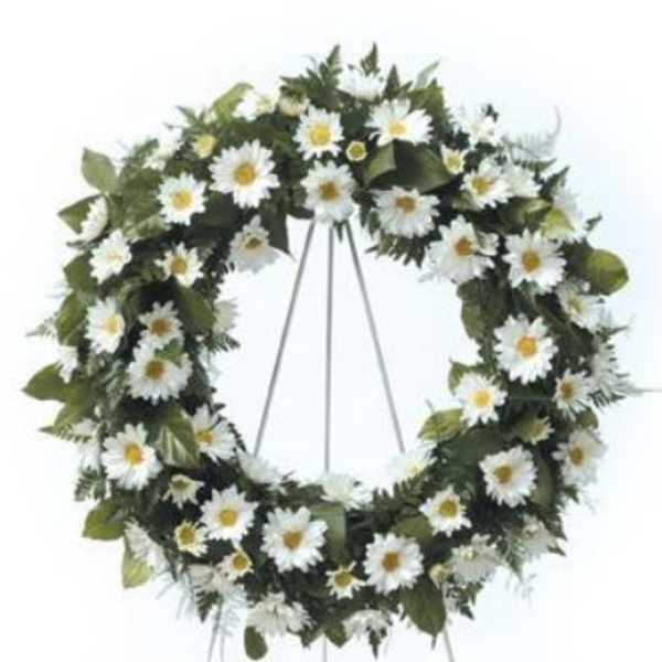 White daisy funeral wreath on a standing easel