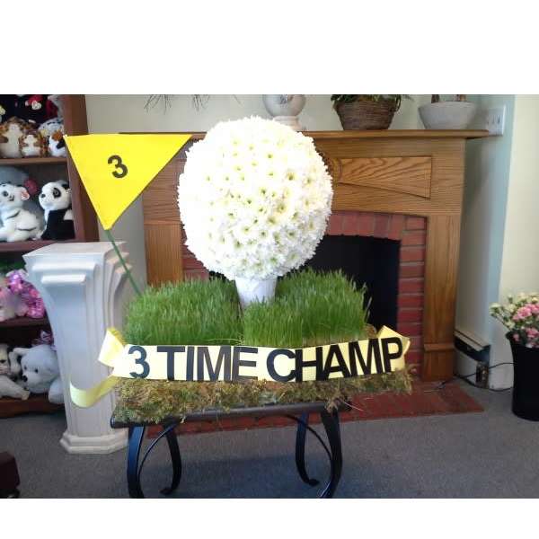 White chrysanthemum topiary with a "3 TIME CHAMP" ribbon