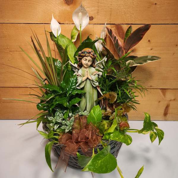 Basket arrangement with a figurine angel and white peace lilies