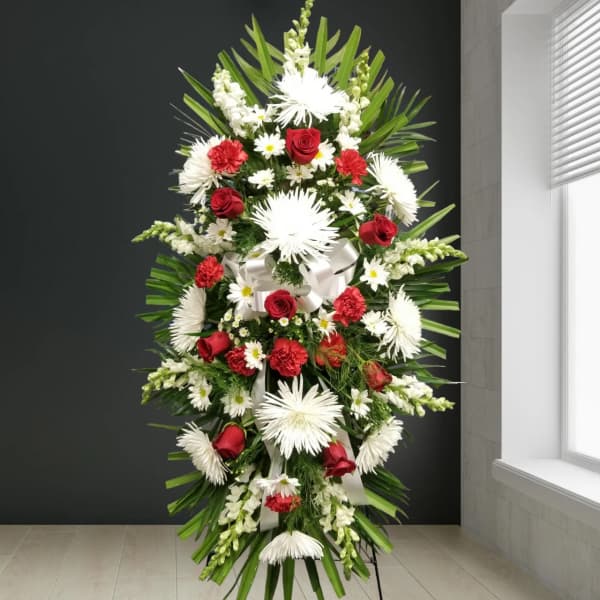 Tall standing floral spray with red roses and white daisies