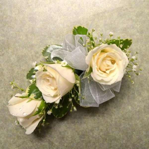 Cream rose corsage with silver ribbon and small white filler flowers