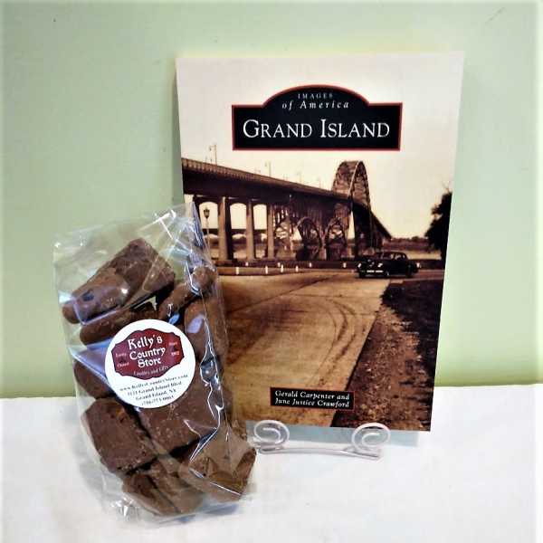 Bag of chocolates beside a Grand Island book