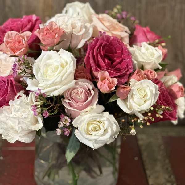 Bouquet of pink and white roses in a glass vase