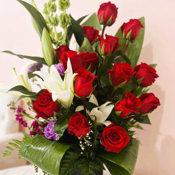 Red roses and white lilies in a black vase