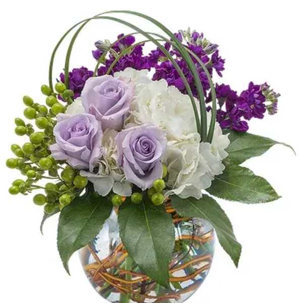 Lavender roses and white hydrangea in a glass vase with purple flowers