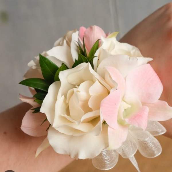Small wrist corsage with white and pale pink flowers