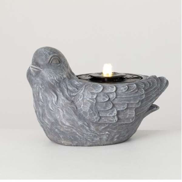 Gray bird-shaped candle holder with a lit tealight