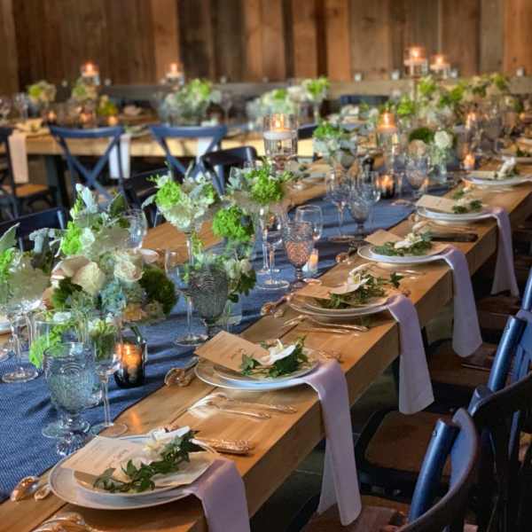 Long banquet tables with white floral centerpieces and candles