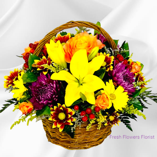 Basket of yellow, orange, and purple flowers