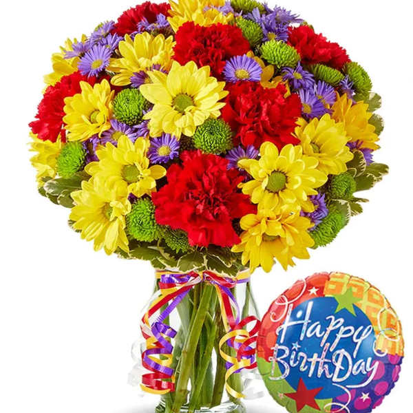 Colorful bouquet of daisies and carnations in a glass vase with a birthday balloon