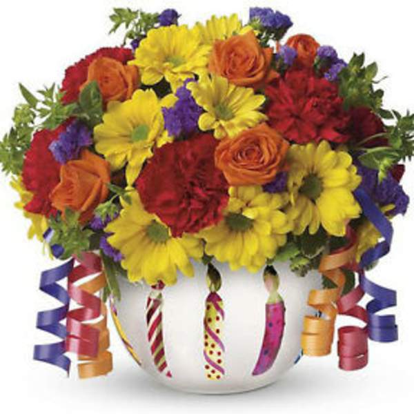 Colorful bouquet in a white vase with curled ribbon accents