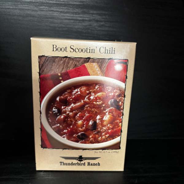 Box of Boot Scootin' Chili mix on a dark surface