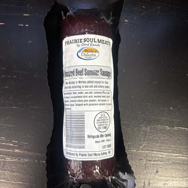 Packaged beef summer sausage in black wrapping