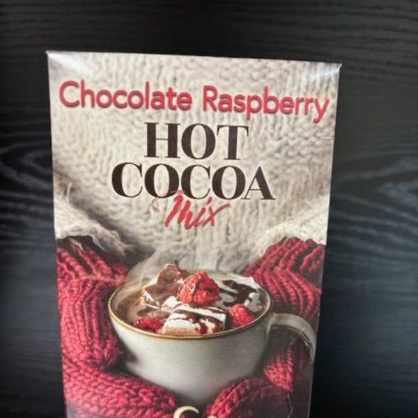 Chocolate raspberry hot cocoa mix box on a dark surface