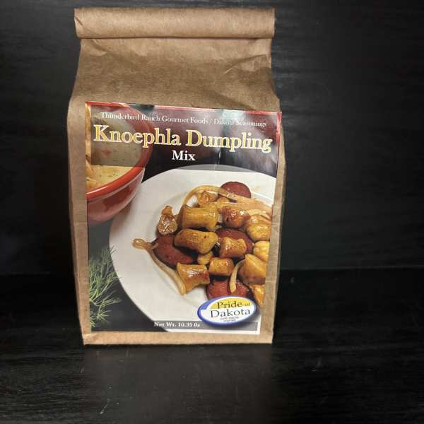Brown paper pouch of Knoephla Dumpling Mix on a dark surface
