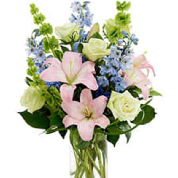 Pink lilies and white roses in a clear glass vase